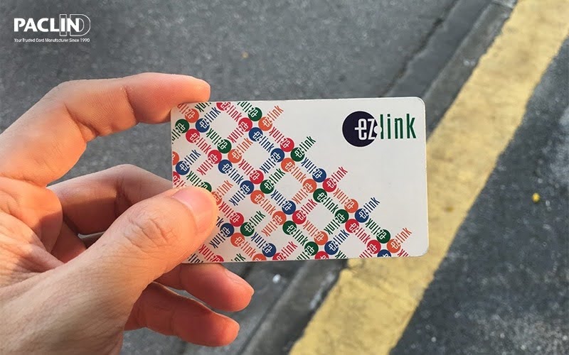 Hand holding an EZ-Link card for daily benefits.